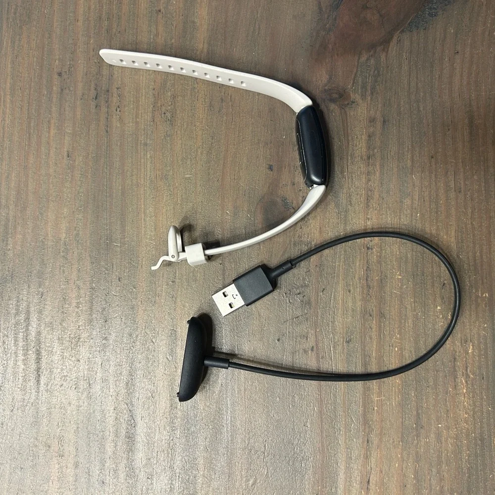 Black and White Fitness Tracker (FitBit with charger)